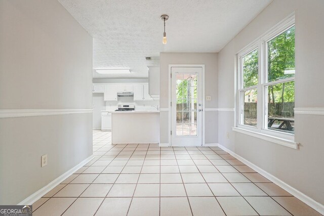 3366 English Oaks Dr NW, Kennesaw, GA 30144 - unfurnished dining area with a textured ceiling and light tile patterned flooring