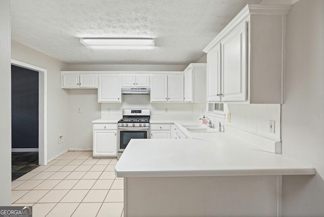 3366 English Oaks Dr NW, Kennesaw, GA 30144 - kitchen with gas stove, under cabinet range hood, a peninsula, white cabinetry, and light countertops