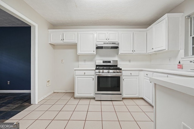 3366 English Oaks Dr NW, Kennesaw, GA 30144 - kitchen with stainless steel gas range, under cabinet range hood, white cabinetry, light countertops, and a textured ceiling