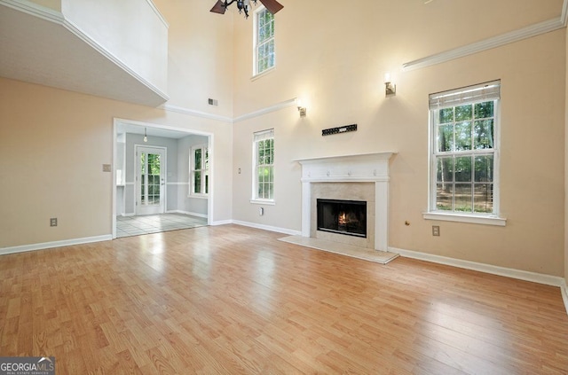 3366 English Oaks Dr NW, Kennesaw, GA 30144 - unfurnished living room with wood finished floors, plenty of natural light, ceiling fan, and a towering ceiling