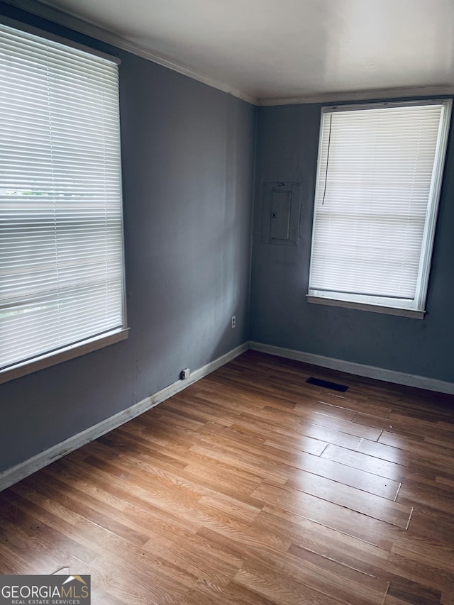 294 Pursley St, Macon, GA 31201 - spare room with electric panel, wood finished floors, and crown molding