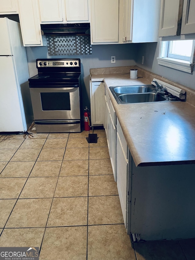 294 Pursley St, Macon, GA 31201 - kitchen featuring stainless steel electric stove, freestanding refrigerator, under cabinet range hood, and white cabinets