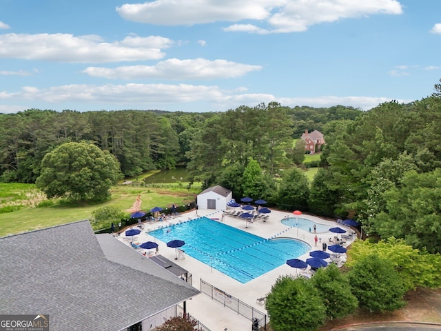 15305 Highgrove Rd, Milton, GA 30004 - community pool featuring a forest view, a patio area, and a storage shed