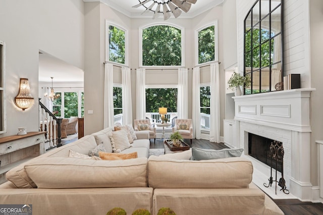 15305 Highgrove Rd, Milton, GA 30004 - living room with a towering ceiling, a chandelier, a fireplace, and ornamental molding