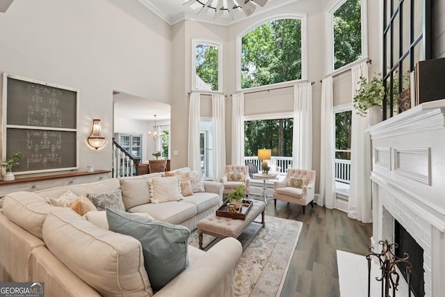 15305 Highgrove Rd, Milton, GA 30004 - living area with a chandelier, a towering ceiling, healthy amount of natural light, a fireplace with flush hearth, and crown molding