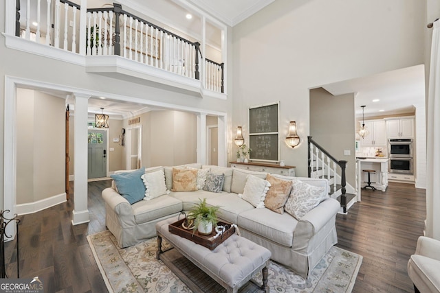 15305 Highgrove Rd, Milton, GA 30004 - living area featuring ornamental molding, a towering ceiling, stairs, dark wood-style floors, and recessed lighting