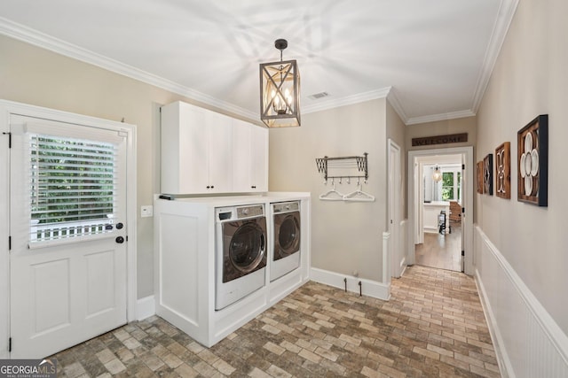 15305 Highgrove Rd, Milton, GA 30004 - laundry area featuring cabinet space, washer and dryer, brick patterned flooring, crown molding, and a chandelier