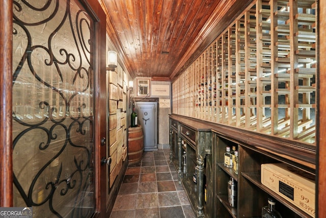 15305 Highgrove Rd, Milton, GA 30004 - wine cellar with wood ceiling, dark stone finish flooring, and crown molding