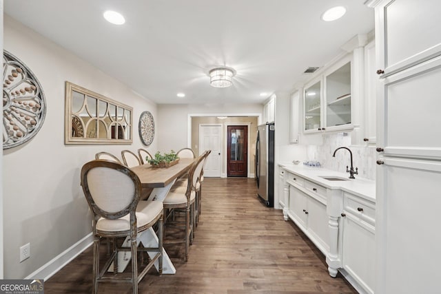 15305 Highgrove Rd, Milton, GA 30004 - kitchen with freestanding refrigerator, glass insert cabinets, white cabinets, dark wood-type flooring, and light countertops