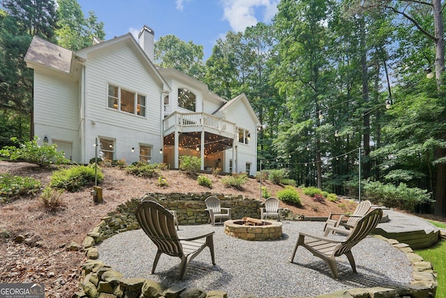 15305 Highgrove Rd, Milton, GA 30004 - back of property featuring a fire pit, a chimney, a patio, and a deck