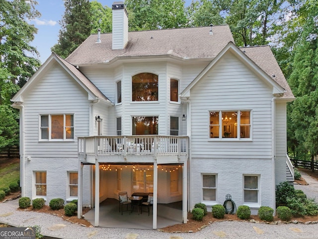 15305 Highgrove Rd, Milton, GA 30004 - rear view of property featuring a patio, a chimney, a deck, and roof with shingles