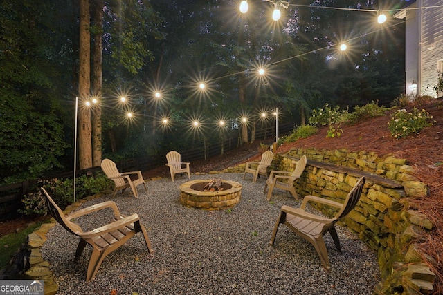 15305 Highgrove Rd, Milton, GA 30004 - patio at night with an outdoor fire pit and a patio