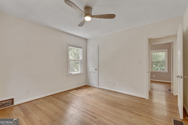 1131 Forrest Blvd, Decatur, GA 30030 - unfurnished room featuring a ceiling fan, light wood-type flooring, and a textured ceiling
