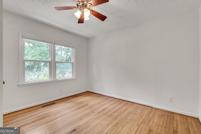 1131 Forrest Blvd, Decatur, GA 30030 - unfurnished room with a textured ceiling, wood finished floors, and ceiling fan