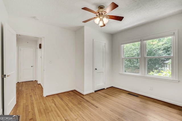 1131 Forrest Blvd, Decatur, GA 30030 - unfurnished room with attic access, light wood-type flooring, a textured ceiling, ceiling fan, and a smoke detector