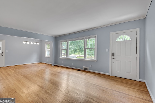 1131 Forrest Blvd, Decatur, GA 30030 - foyer with healthy amount of natural light, light wood-style floors, and ornamental molding