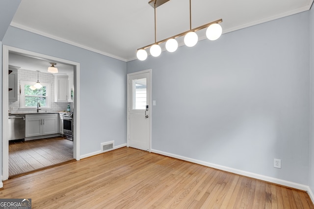 1131 Forrest Blvd, Decatur, GA 30030 - unfurnished dining area with light wood finished floors and ornamental molding