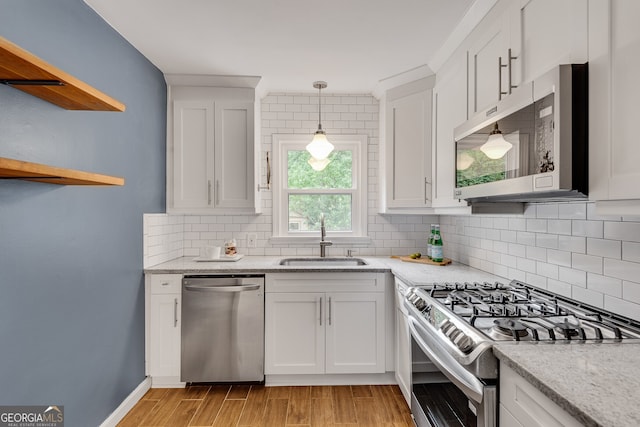 1131 Forrest Blvd, Decatur, GA 30030 - kitchen featuring appliances with stainless steel finishes, white cabinetry, tasteful backsplash, light wood-style floors, and open shelves