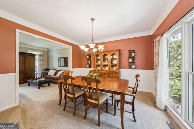 9320 Old Preserve Trl, Ball Ground, GA 30107 - dining room featuring wainscoting, light carpet, crown molding, and a chandelier