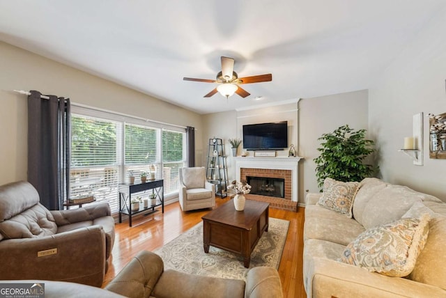 9320 Old Preserve Trl, Ball Ground, GA 30107 - living room featuring ceiling fan, light wood-type flooring, and a brick fireplace