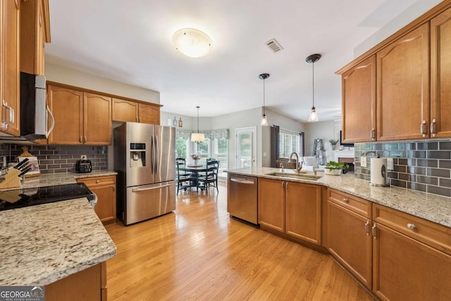 9320 Old Preserve Trl, Ball Ground, GA 30107 - kitchen with appliances with stainless steel finishes, brown cabinets, and a peninsula