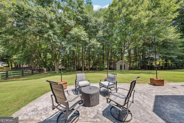 9320 Old Preserve Trl, Ball Ground, GA 30107 - view of patio featuring an outdoor structure, a fire pit, and view of wooded area