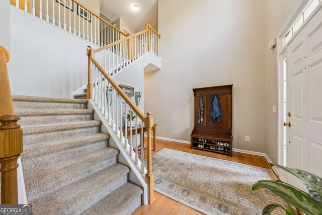 9320 Old Preserve Trl, Ball Ground, GA 30107 - foyer featuring a high ceiling, stairs, and wood finished floors