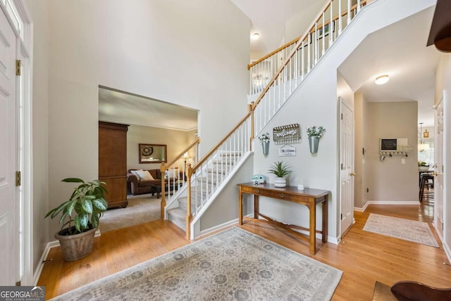 9320 Old Preserve Trl, Ball Ground, GA 30107 - foyer featuring stairs, wood finished floors, and a high ceiling