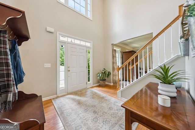 9320 Old Preserve Trl, Ball Ground, GA 30107 - foyer entrance featuring stairway, wood finished floors, and a high ceiling