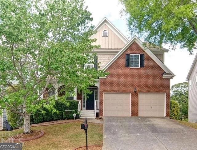 4518 Columbus Cir, Acworth, GA 30101 - view of front of home with board and batten siding, driveway, an attached garage, brick siding, and a front lawn