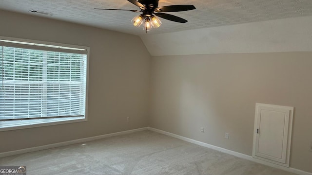 3066 Gem Creek Rd, Buford, GA 30519 - unfurnished room with ceiling fan, vaulted ceiling, light carpet, and a textured ceiling