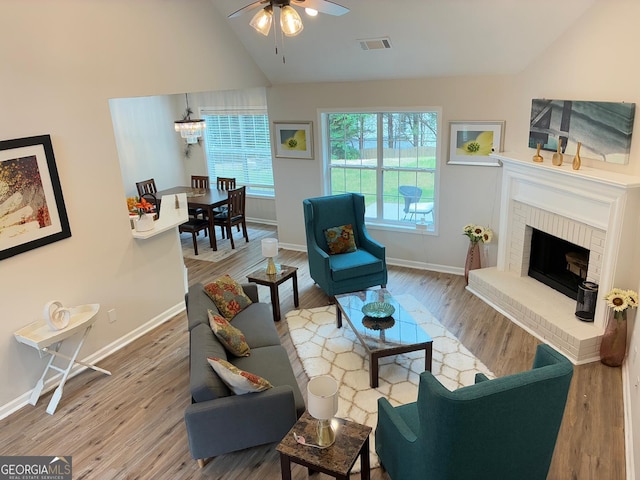 3066 Gem Creek Rd, Buford, GA 30519 - living room with ceiling fan, wood finished floors, a brick fireplace, and high vaulted ceiling