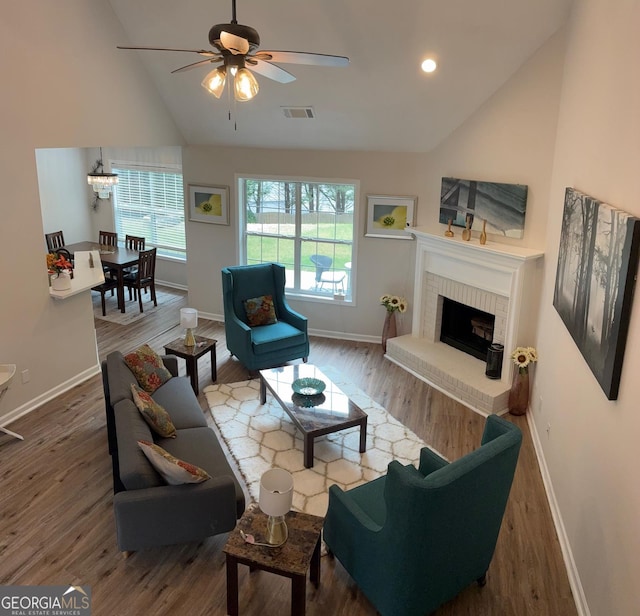 3066 Gem Creek Rd, Buford, GA 30519 - living area featuring wood finished floors, ceiling fan, a brick fireplace, and high vaulted ceiling