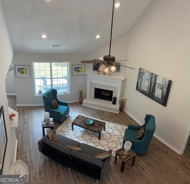 3066 Gem Creek Rd, Buford, GA 30519 - living room with wood finished floors, recessed lighting, a ceiling fan, a brick fireplace, and vaulted ceiling