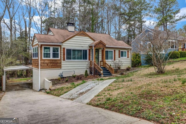 1747 Parkhill Dr, Decatur, GA 30032 - bungalow featuring a chimney, concrete driveway, a carport, and roof with shingles