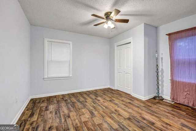 1747 Parkhill Dr, Decatur, GA 30032 - unfurnished bedroom featuring wood finished floors, a textured ceiling, a closet, and ceiling fan