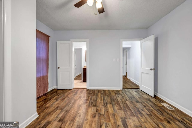 1747 Parkhill Dr, Decatur, GA 30032 - unfurnished bedroom featuring wood finished floors, a textured ceiling, connected bathroom, and a ceiling fan
