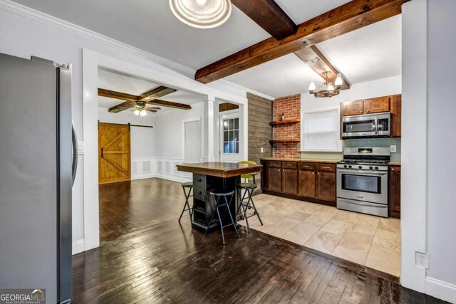 1747 Parkhill Dr, Decatur, GA 30032 - kitchen with stainless steel appliances, a barn door, beamed ceiling, light wood-style flooring, and open shelves