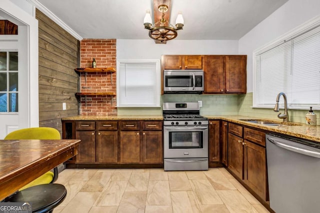 1747 Parkhill Dr, Decatur, GA 30032 - kitchen featuring appliances with stainless steel finishes, a chandelier, light stone countertops, open shelves, and tasteful backsplash