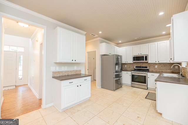 2427 Camata Pl, Marietta, GA 30066 - kitchen featuring stainless steel appliances, dark countertops, ornamental molding, backsplash, and recessed lighting