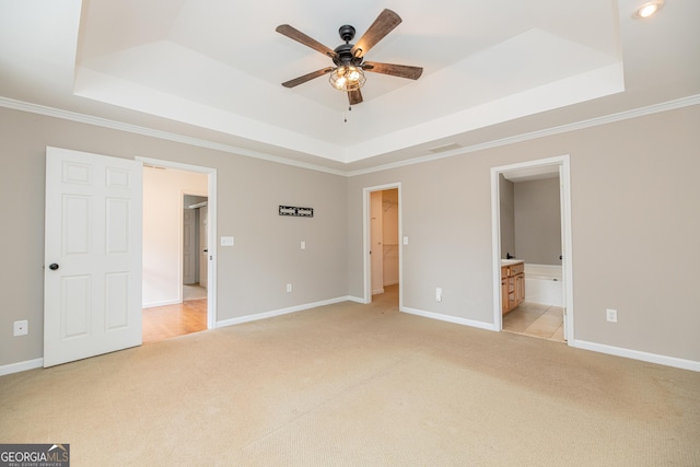 2427 Camata Pl, Marietta, GA 30066 - unfurnished bedroom featuring a raised ceiling, light colored carpet, crown molding, ensuite bath, and a spacious closet