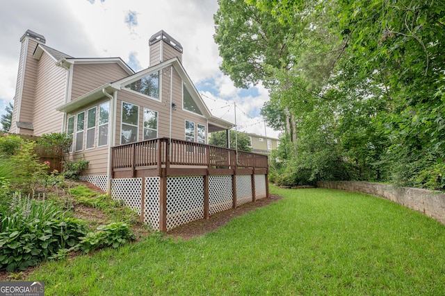 2427 Camata Pl, Marietta, GA 30066 - back of house with a chimney, a lawn, a sunroom, and a deck