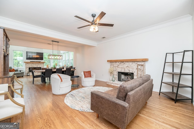 2427 Camata Pl, Marietta, GA 30066 - living area featuring a brick fireplace, crown molding, light wood finished floors, and a ceiling fan