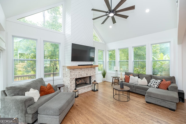 2427 Camata Pl, Marietta, GA 30066 - living area with high vaulted ceiling, a ceiling fan, a fireplace, wood finished floors, and recessed lighting