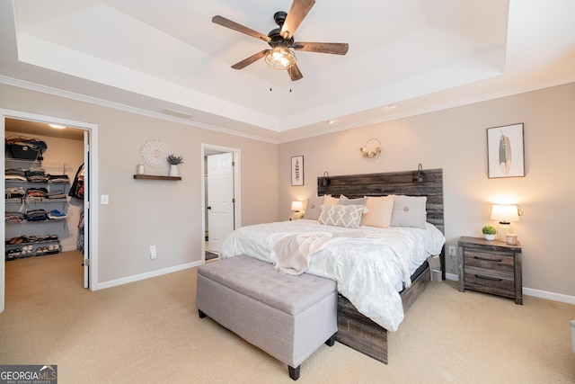 2427 Camata Pl, Marietta, GA 30066 - bedroom with a tray ceiling, light colored carpet, a walk in closet, and crown molding