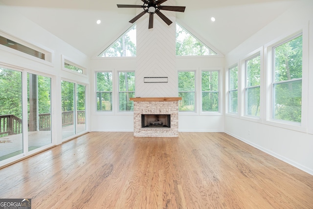 2427 Camata Pl, Marietta, GA 30066 - unfurnished living room featuring high vaulted ceiling, a ceiling fan, plenty of natural light, wood finished floors, and a fireplace