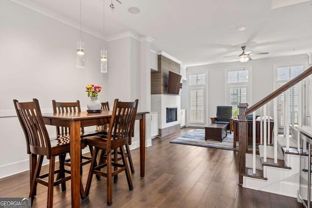 18 Peachtree Ave NE Unit 5, Atlanta, GA 30305 - dining space with a ceiling fan, dark wood-type flooring, a large fireplace, stairway, and ornamental molding