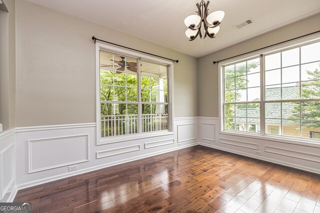 24 Arendt Park Ln, Newnan, GA 30263 - spare room with a chandelier, hardwood / wood-style floors, wainscoting, and a decorative wall