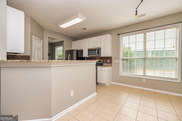 24 Arendt Park Ln, Newnan, GA 30263 - kitchen featuring appliances with stainless steel finishes, tasteful backsplash, white cabinets, and light tile patterned flooring