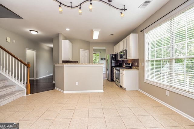 24 Arendt Park Ln, Newnan, GA 30263 - kitchen featuring stainless steel appliances, white cabinets, light tile patterned floors, light stone countertops, and recessed lighting